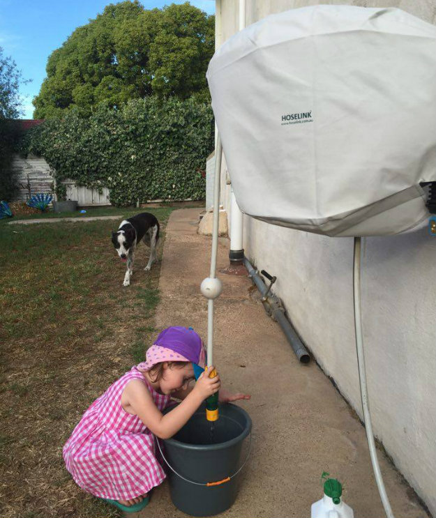 Young child using a Hoselink Retractable Reel